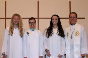 Pictured left to right: Logan Edwards, Joshua Barker, Elaina Riley, and Pastor Rathjen.
